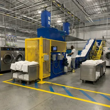 Commercial laundry automation system for restaurant linens